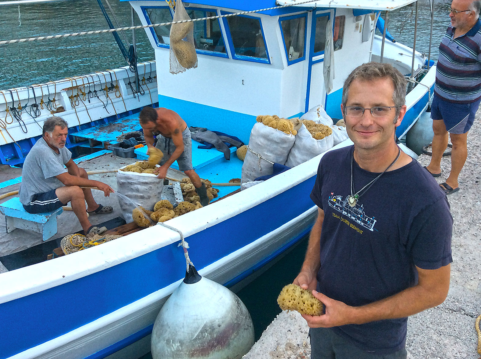 The whole dive team was excited about sponge diving techniques of the past. Here's Evan Kovacs with a locally harvested sponge to take back to the USA as a present.